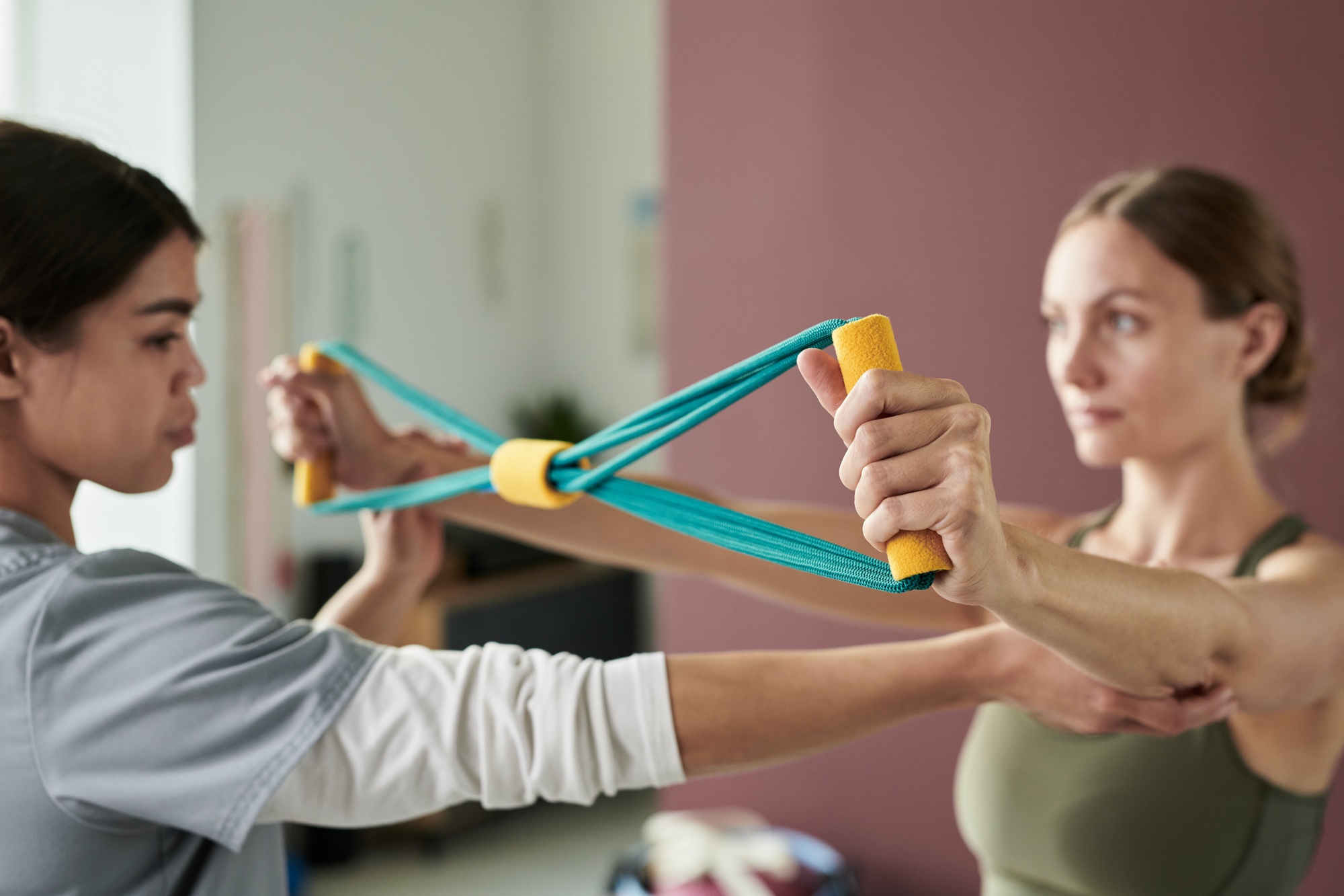 Assisting Woman with Physical Therapy Exercise Band